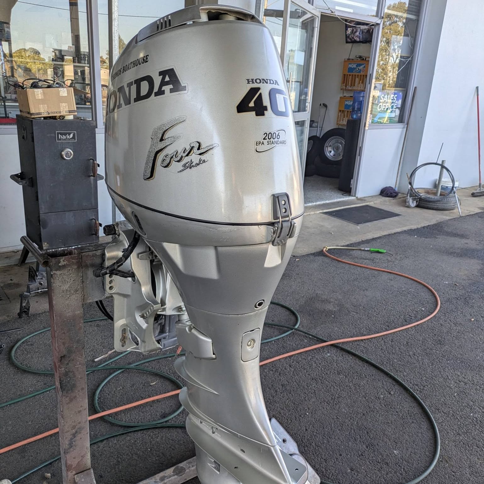 A Honda 40 four stroke standing outside the Bowman's Marine sales office