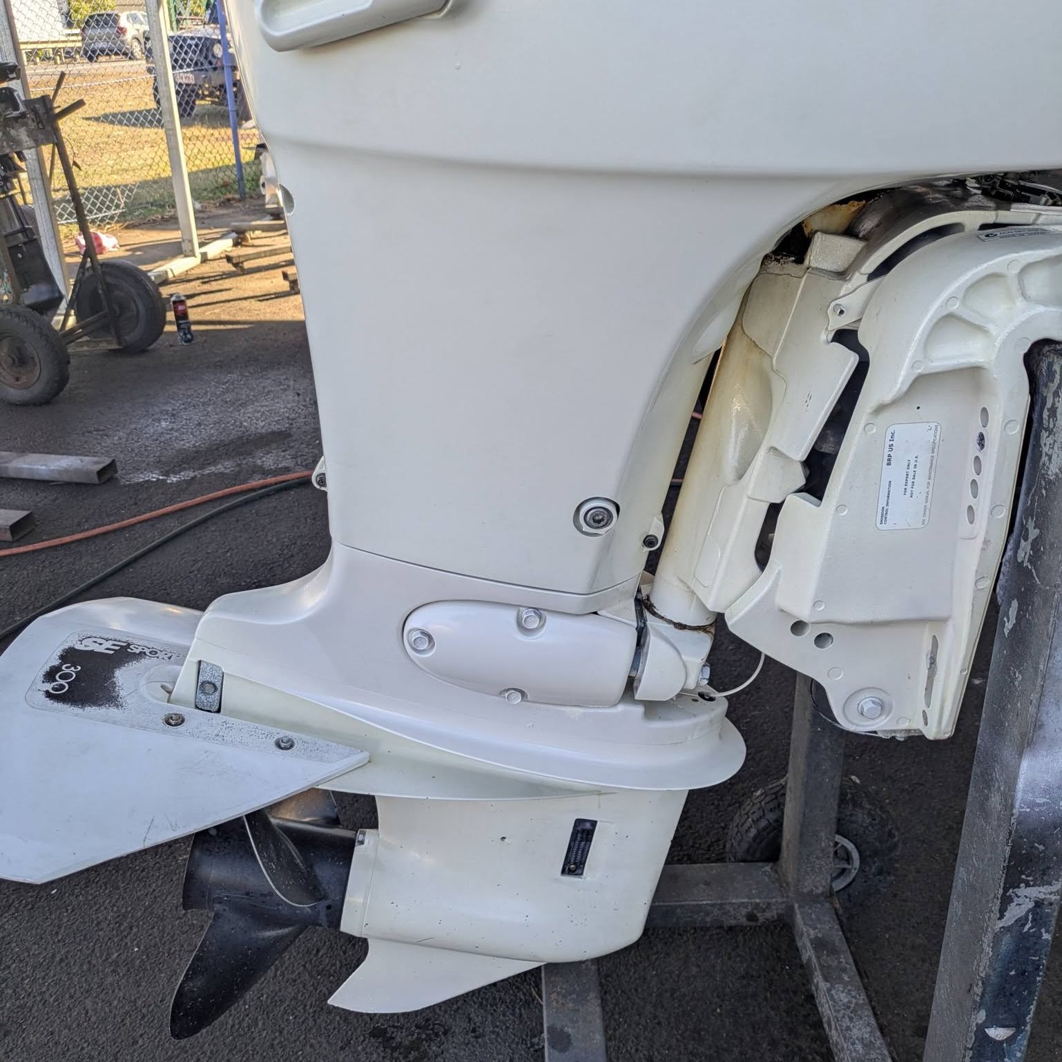 An outboard leg and propeller on a stand