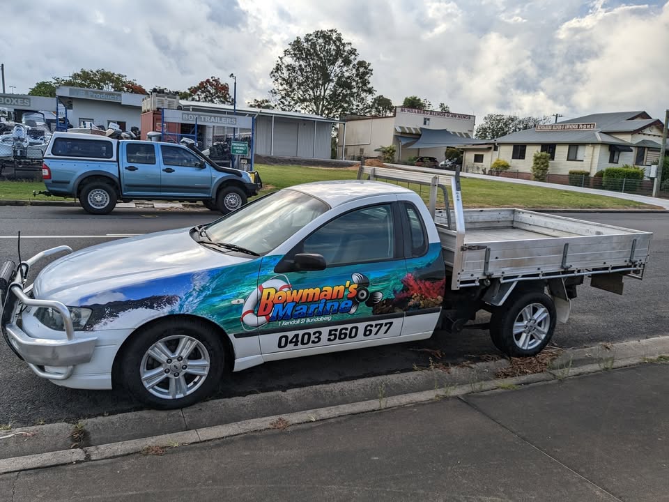 The Bowman's Marine work ute, signwritten with the business name and phone number